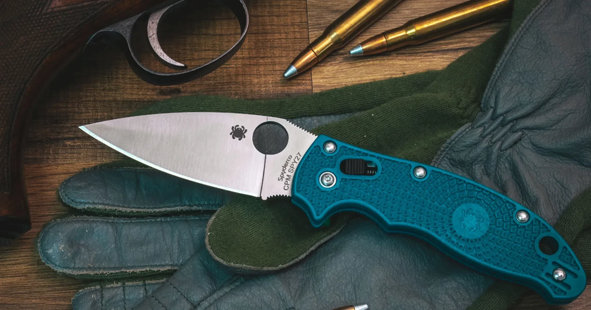 A climbing knife fitted with a blue stainless steel handle