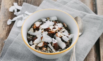 Immering Quinoa With Coconut Milk, Topped With Coconut Flakes And Almonds